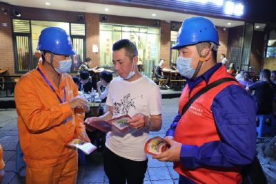 為各個攤位檢查用電安全情況、排查隱患、發(fā)放用電安全宣傳單